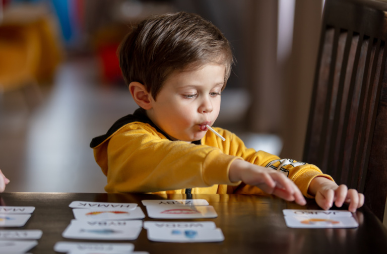 Young mum teaching child to count at home
