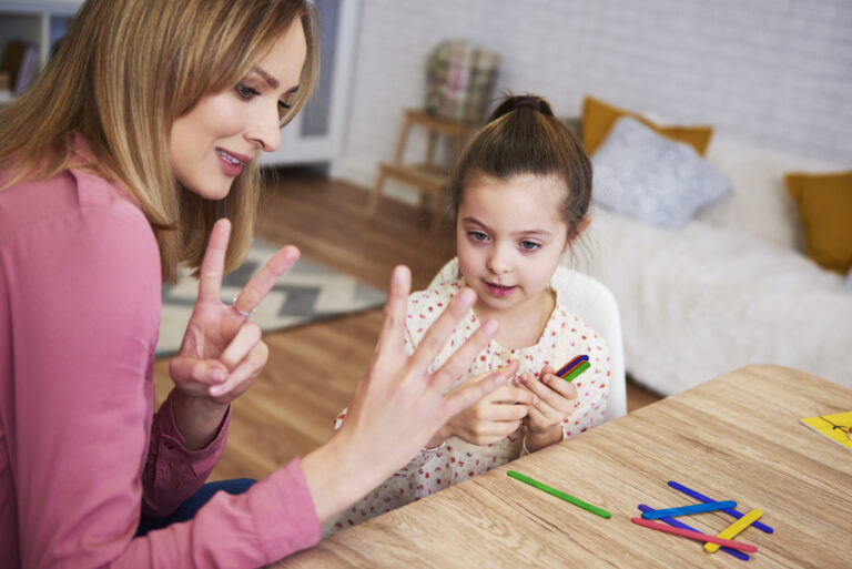 Young mum teaching child to count at home